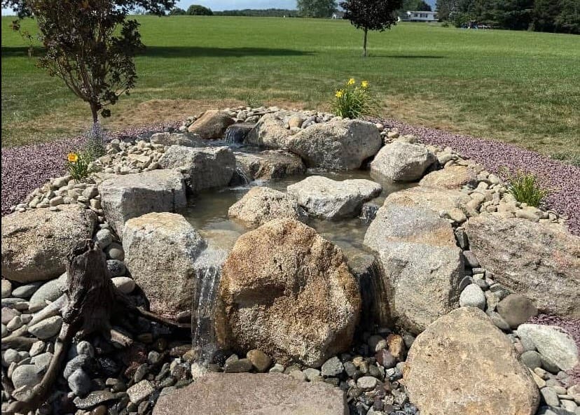 Multi-drop pondless waterfall surrounded by daylilies in Lehighton, PA